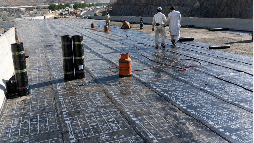Professional commercial roof waterproofing membrane installation by Safwa Contracting on a large-scale construction project in Jeddah, Saudi Arabia.